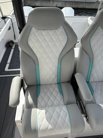 Hull 106 Yacht Photos Pics Luxury seating on 2025 Hammer Yachts HammerCat 30 with quilted design and teal accents.