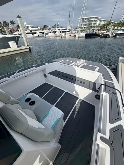 Hull 106 Yacht Photos Pics 2025 Hammer Yachts HammerCat 30 docked at marina, showcasing sleek design and spacious deck.