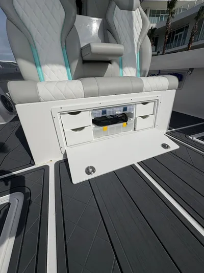 Hull 106 Yacht Photos Pics 2025 Hammer Yachts HammerCat 30 interior seating with storage compartment open.