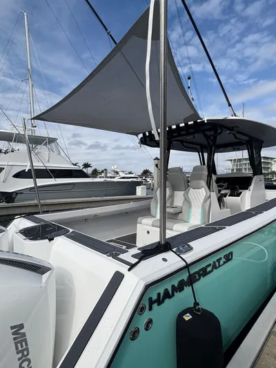 Hull 106 Yacht Photos Pics 2025 Hammer Yachts HammerCat 30 with sleek design and modern seating at a marina.