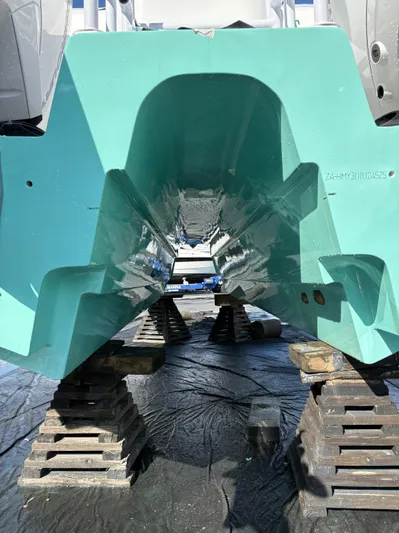 Hull 106 Yacht Photos Pics 2025 Hammer Yachts HammerCat 30 catamaran hull on blocks, turquoise finish.