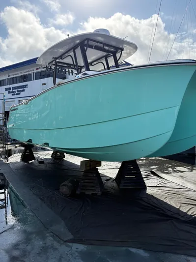 Hull 106 Yacht Photos Pics 2025 Hammer Yachts HammerCat 30 in dry dock, turquoise hull, sunny day.