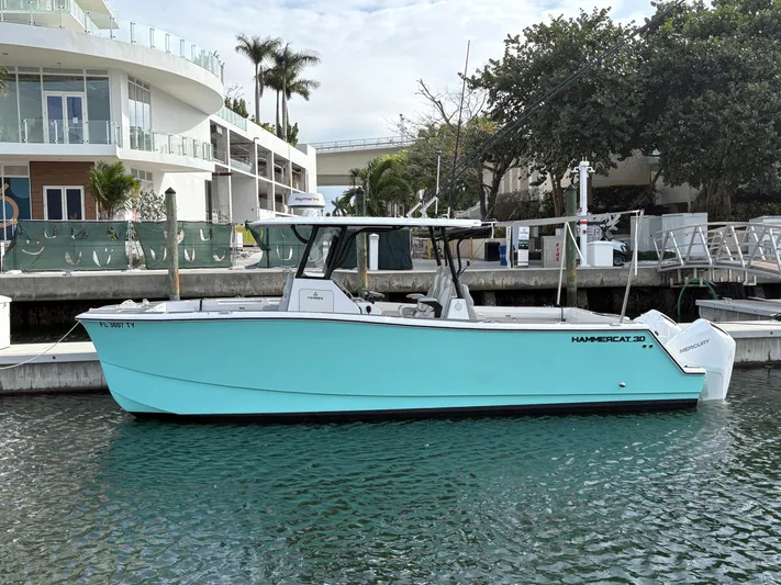 Hull 106 Yacht Photos Pics 2025 Hammer Yachts HammerCat 30 in marina, turquoise hull, modern design.