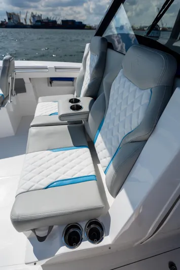 Hull 106 Yacht Photos Pics Luxury seating on 2025 Hammer Yachts HammerCat 30, featuring quilted upholstery and cup holders.