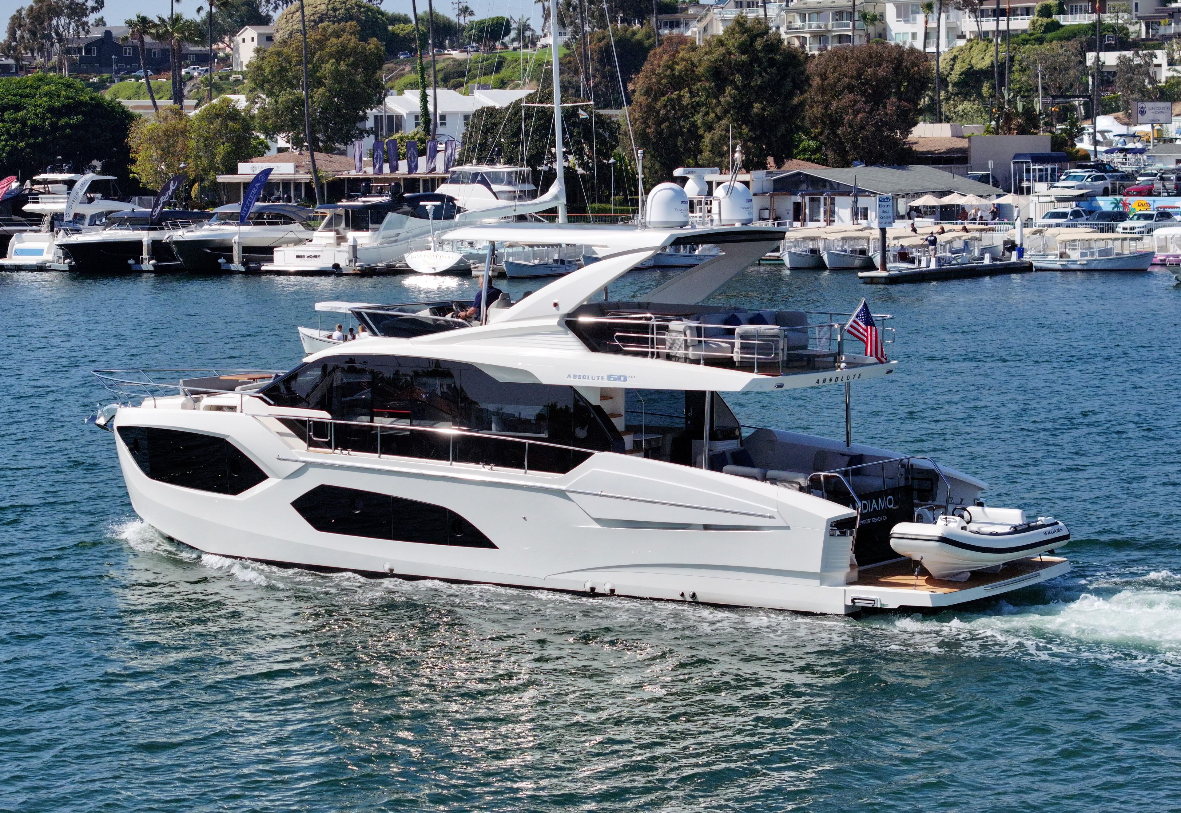 2024 Absolute 60 Fly Co Ownership yacht cruising in a marina with other boats.