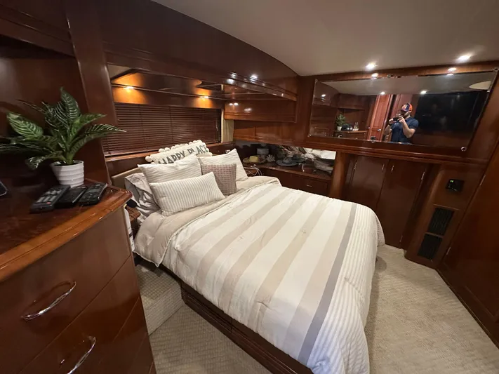  Yacht Photos Pics Luxurious bedroom interior of 2005 Carver 56 Voyager yacht with elegant wood finishes.