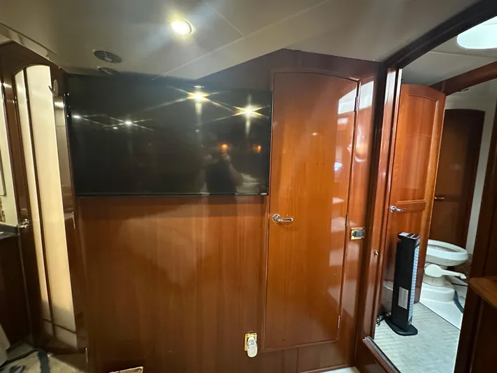  Yacht Photos Pics Interior of 2005 Carver 56 Voyager yacht with wood paneling and mounted TV.