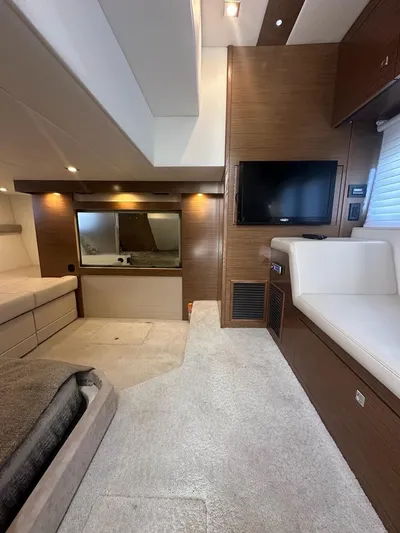 Jubilant Yacht Photos Pics Luxurious interior of 2015 Cruisers Yachts 45 Cantius with modern furnishings and TV.