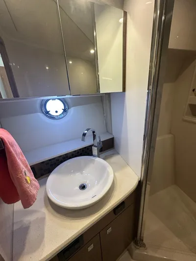 Jubilant Yacht Photos Pics Luxurious bathroom in 2015 Cruisers Yachts 45 Cantius with modern sink and mirror.