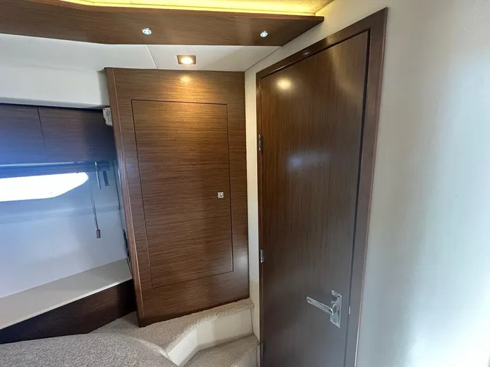 Jubilant Yacht Photos Pics Interior of 2015 Cruisers Yachts 45 Cantius with wooden door and modern lighting.