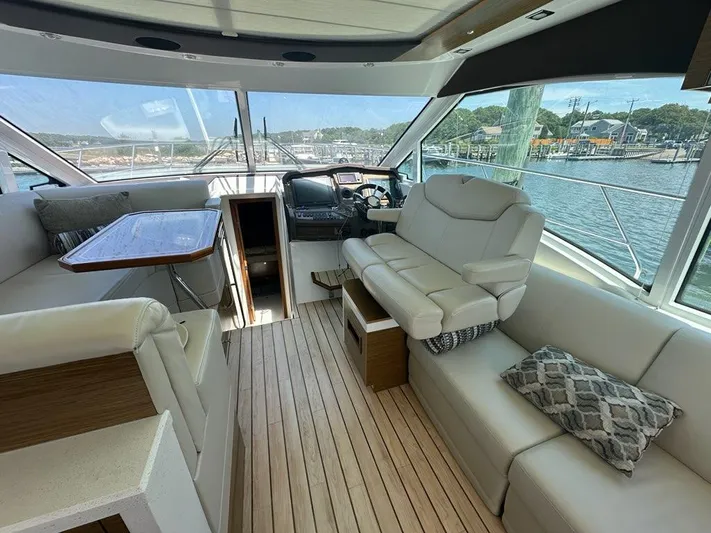 Jubilant Yacht Photos Pics Luxurious interior of 2015 Cruisers Yachts 45 Cantius with plush seating and scenic views.