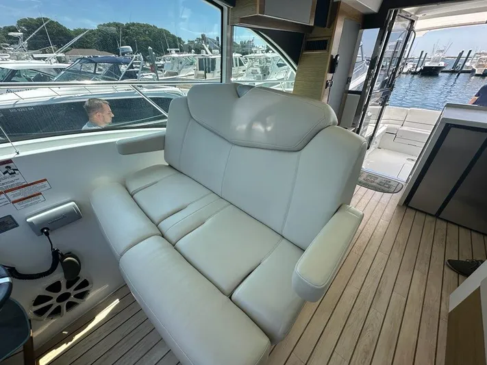 Jubilant Yacht Photos Pics Luxurious interior of 2015 Cruisers Yachts 45 Cantius with leather seating and marina view.