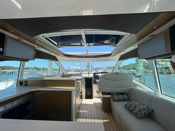 Jubilant Yacht Photos Pics Interior of 2015 Cruisers Yachts 45 Cantius with panoramic windows and modern seating.