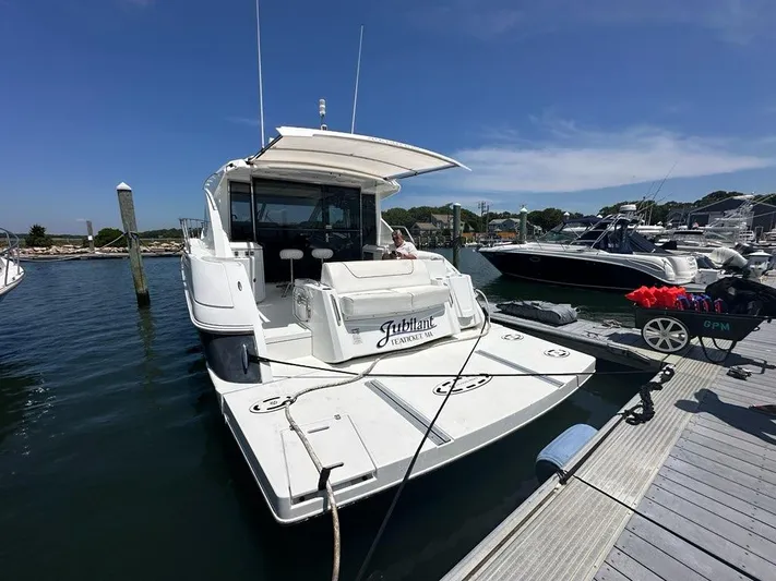 Jubilant Yacht Photos Pics 2015 Cruisers Yachts 45 Cantius docked at marina under clear blue sky.