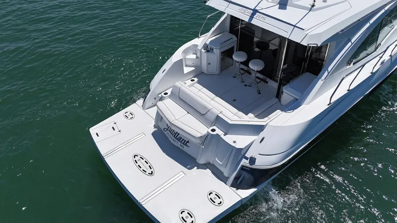 Jubilant Yacht Photos Pics 2015 Cruisers Yachts 45 Cantius on water, featuring spacious deck and seating area.