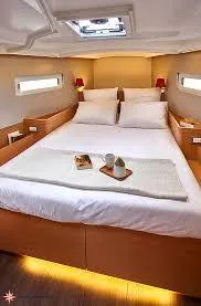  Yacht Photos Pics 2024 Jeanneau Sun Odyssey 410 cabin interior with cozy bed and modern design.