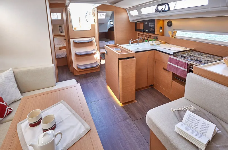  Yacht Photos Pics Interior of 2024 Jeanneau Sun Odyssey 410 yacht, featuring modern kitchen and cozy seating area.