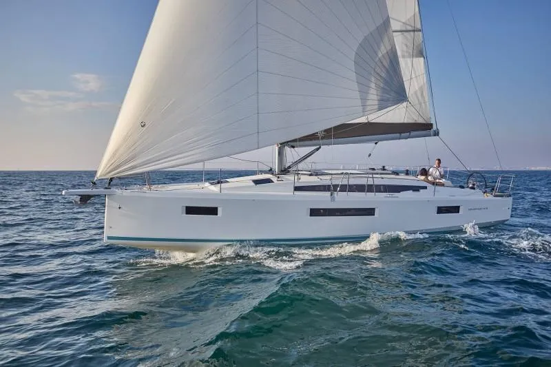  Yacht Photos Pics 2024 Jeanneau Sun Odyssey 410 sailing on open water, showcasing sleek design and performance.