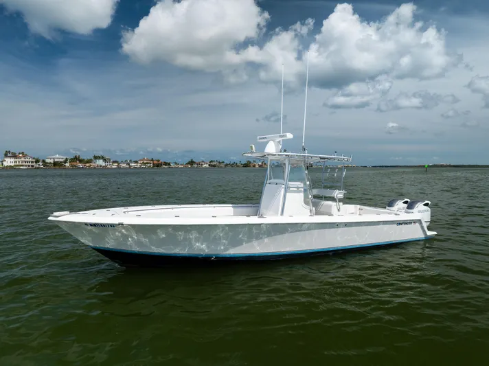  Yacht Photos Pics 2008 Contender 31 Open boat on calm water under a partly cloudy sky.