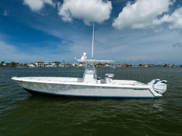  Yacht Photos Pics 2008 Contender 31 Open boat on water, clear sky, coastal background.