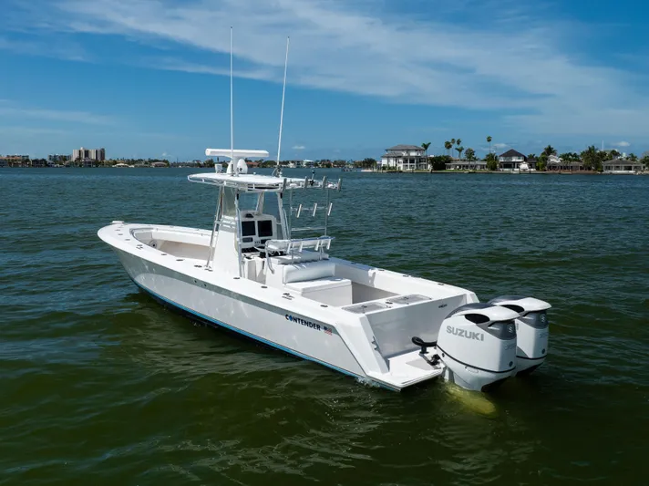  Yacht Photos Pics 2008 Contender 31 Open boat with twin Suzuki engines on calm water.