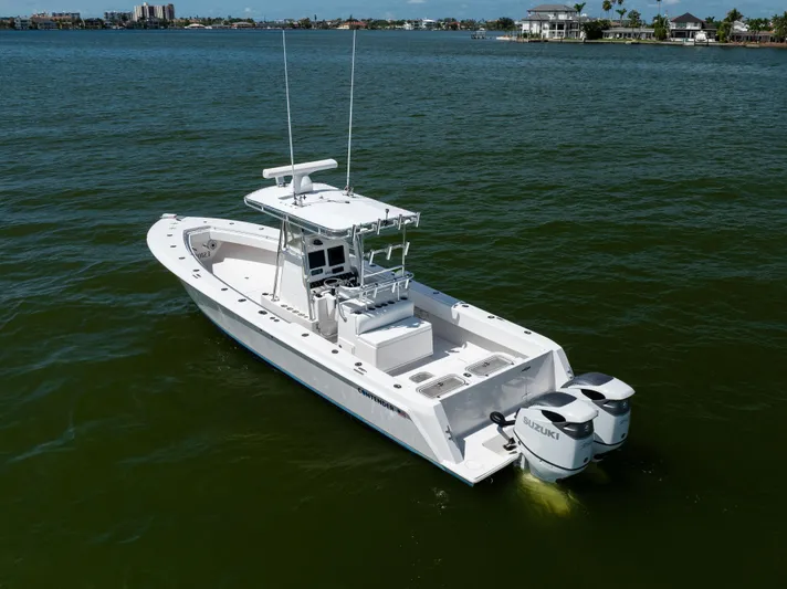  Yacht Photos Pics 2008 Contender 31 Open boat with dual Suzuki engines on calm water.