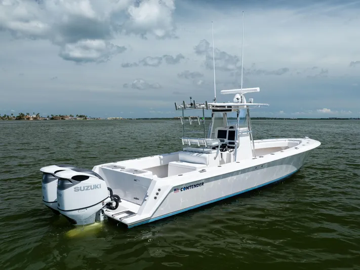  Yacht Photos Pics 2008 Contender 31 Open boat with dual Suzuki engines on calm water.