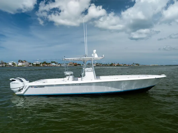  Yacht Photos Pics 2008 Contender 31 Open boat on water, featuring Suzuki engines, under a partly cloudy sky.