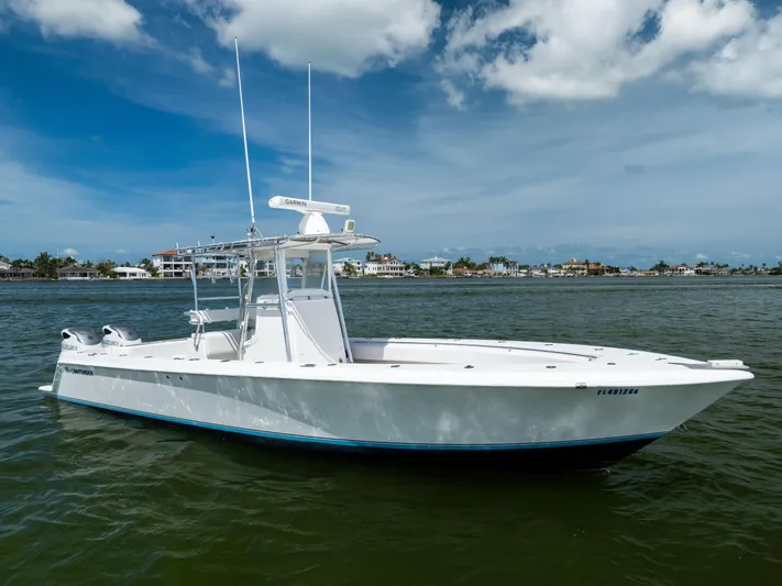  Yacht Photos Pics 2008 Contender 31 Open boat on water, clear sky, coastal background.