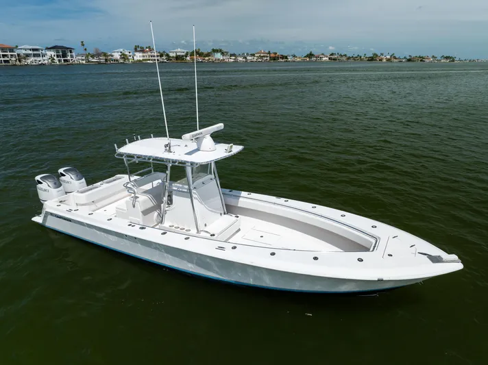  Yacht Photos Pics 2008 Contender 31 Open boat on calm water, featuring dual Suzuki engines.