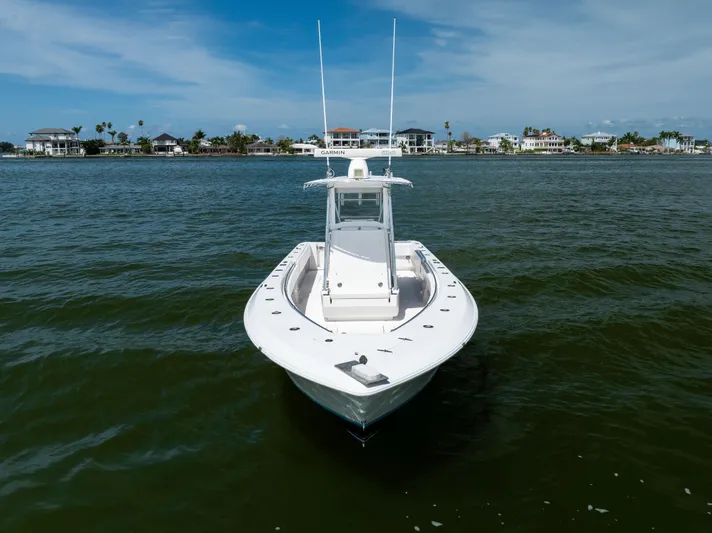  Yacht Photos Pics 2008 Contender 31 Open boat on calm water with coastal homes in the background.