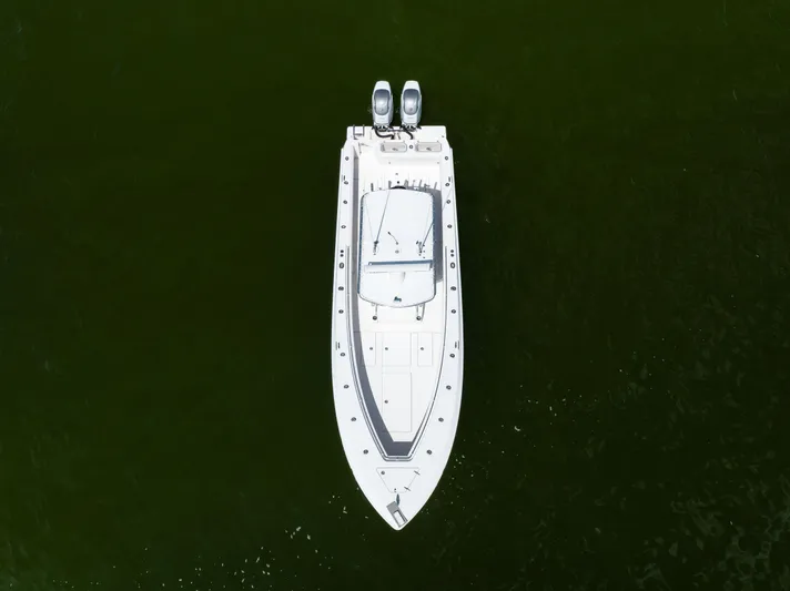  Yacht Photos Pics Aerial view of 2008 Contender 31 Open boat on dark green water.