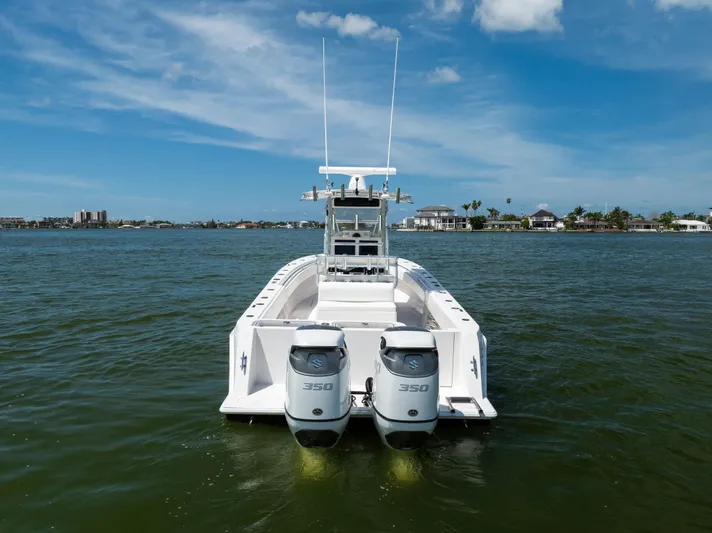  Yacht Photos Pics 2008 Contender 31 Open boat with dual 350 engines on calm water, clear sky background.