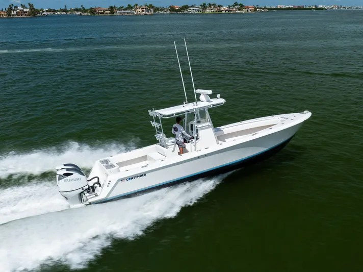  Yacht Photos Pics 2008 Contender 31 Open boat cruising on water with Suzuki engines.
