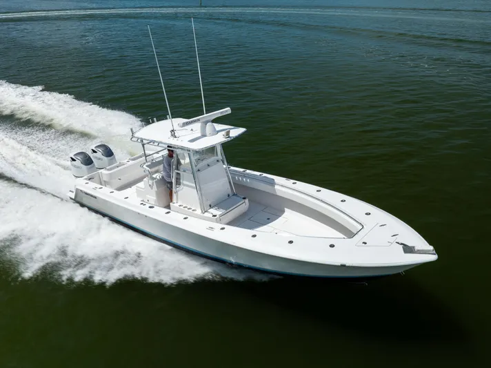  Yacht Photos Pics 2008 Contender 31 Open boat cruising on water with dual outboard engines.