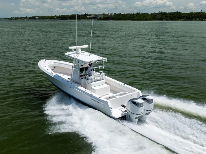  Yacht Photos Pics 2008 Contender 31 Open boat cruising on water with twin engines, clear sky background.
