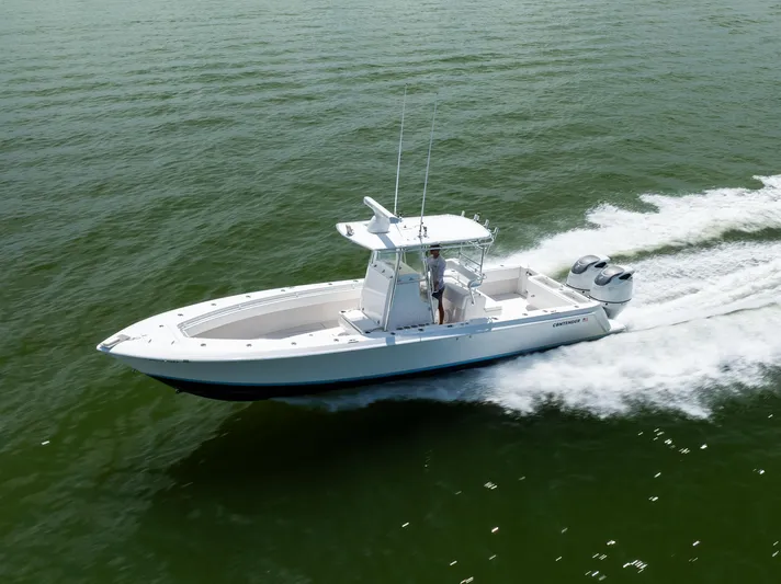 Yacht Photos Pics 2008 Contender 31 Open boat cruising on open water, showcasing sleek design and twin engines.