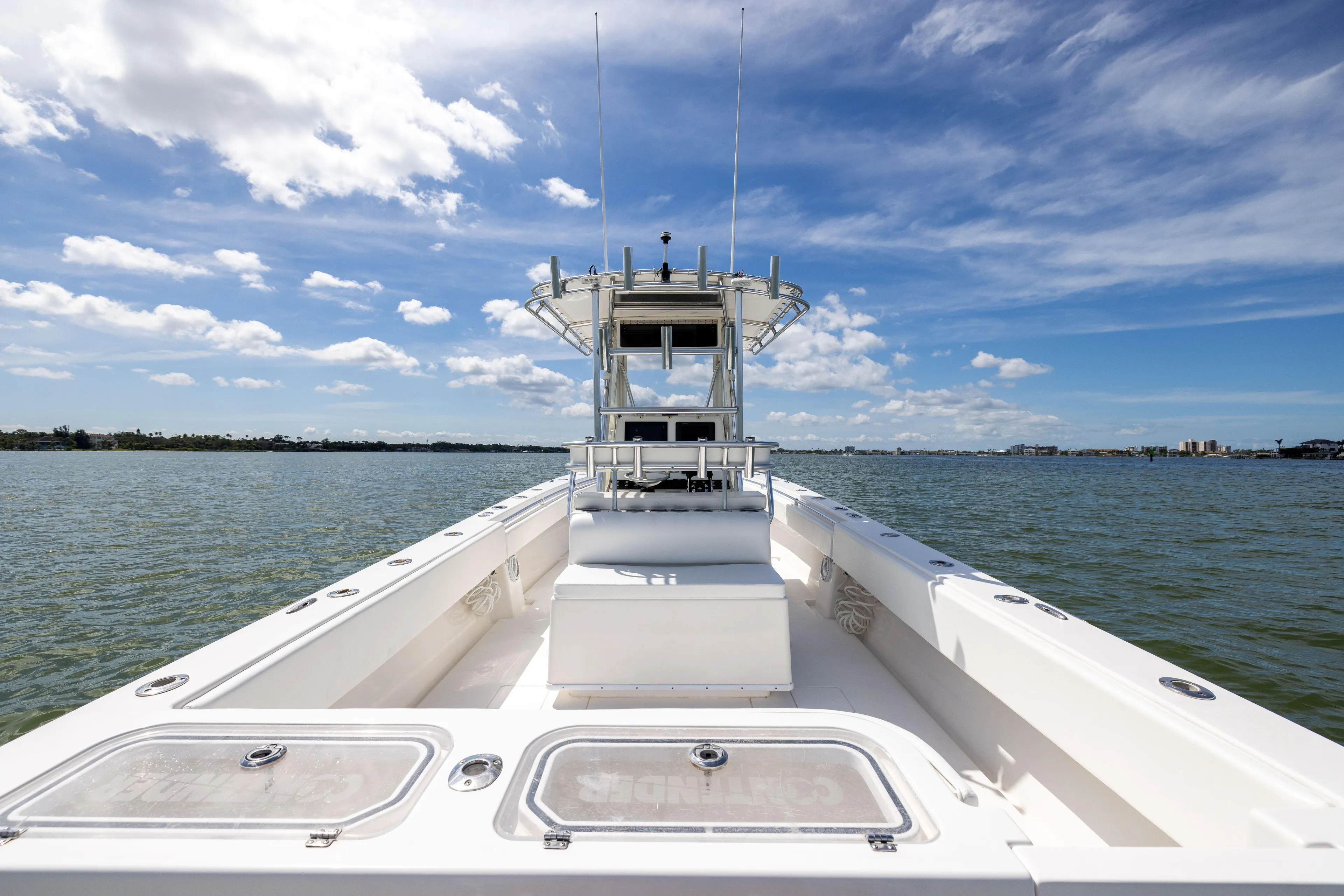  Yacht Photos Pics 2008 Contender 31 Open boat on calm water under a blue sky.