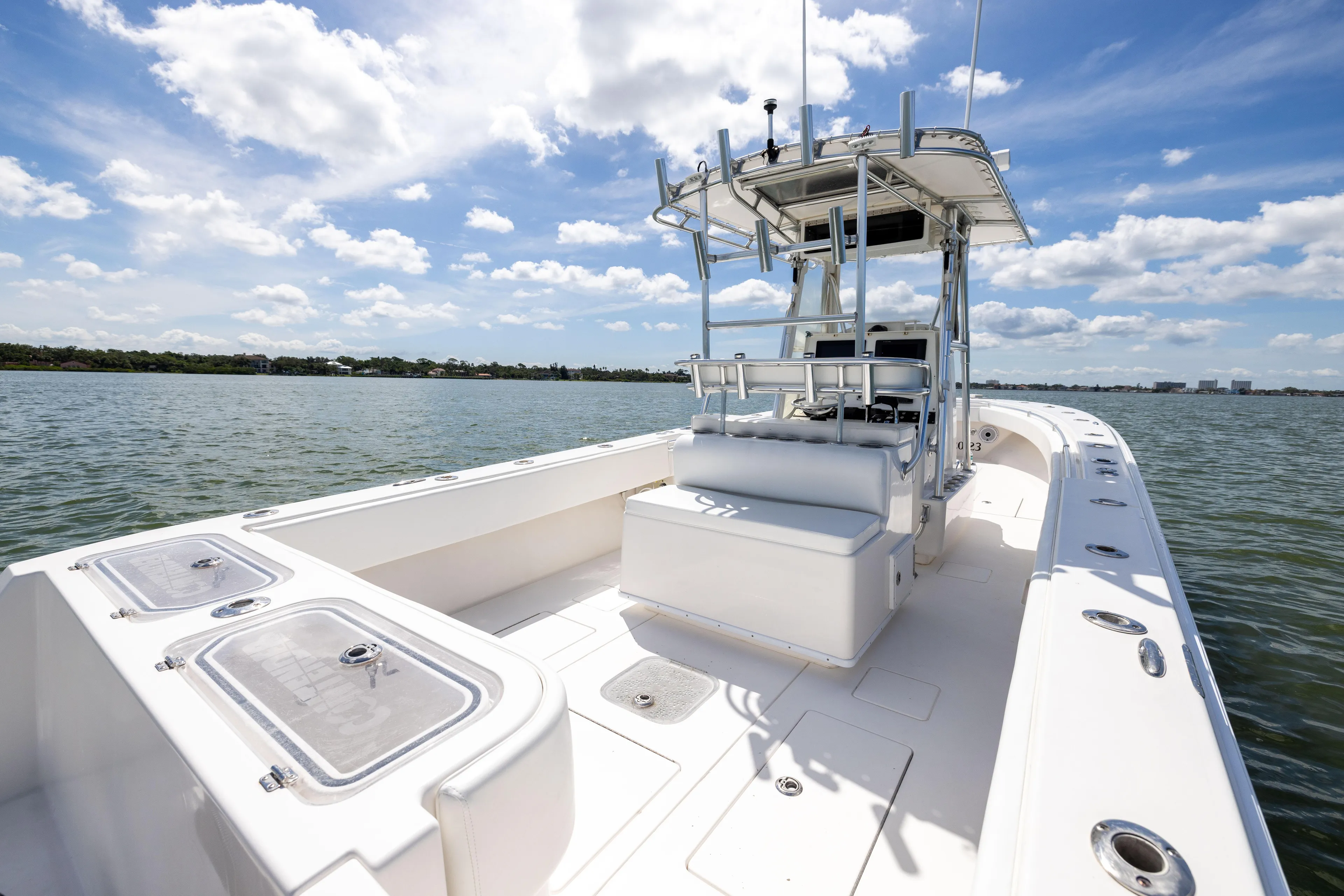  Yacht Photos Pics 2008 Contender 31 Open boat on calm water under a partly cloudy sky.