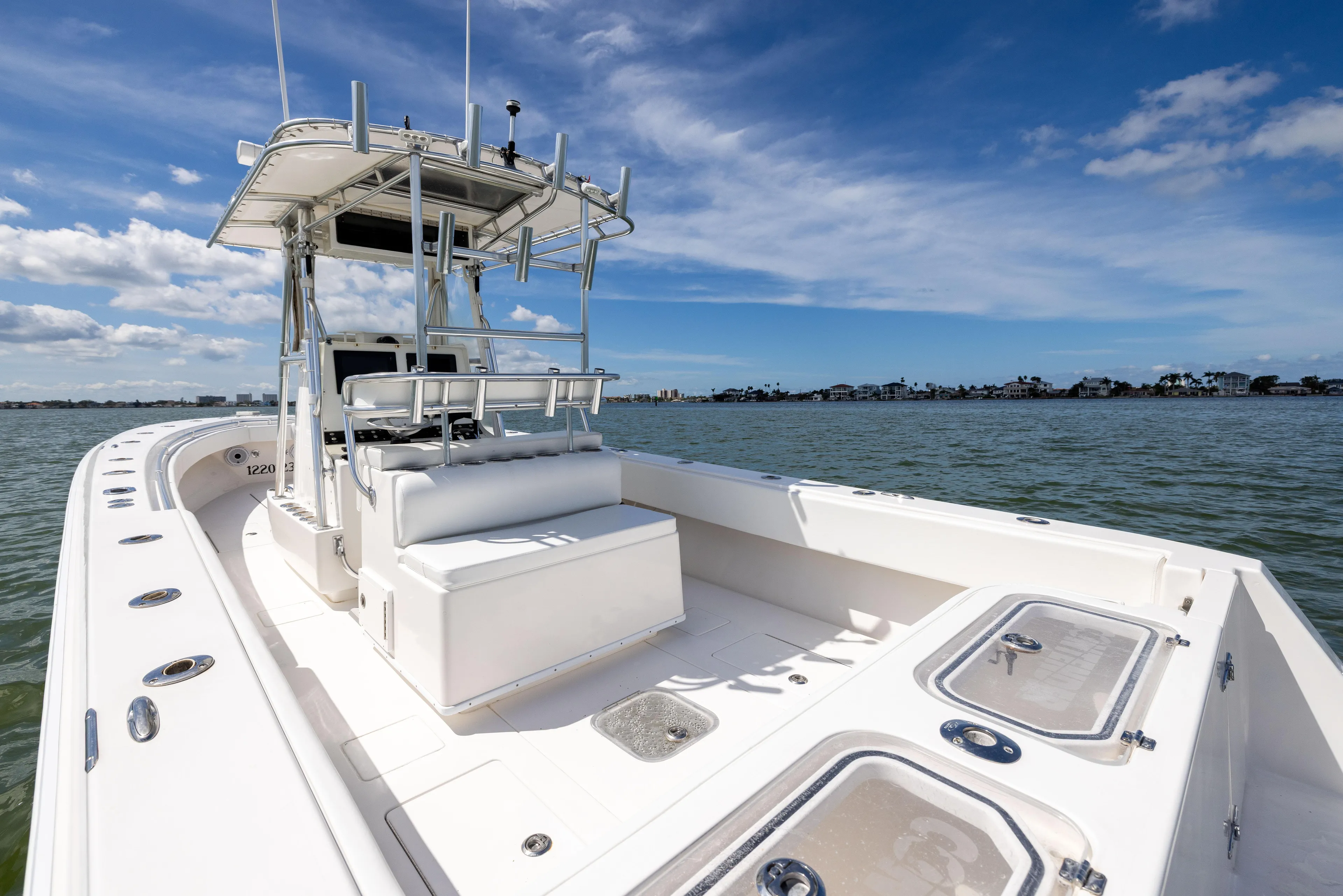  Yacht Photos Pics 2008 Contender 31 Open boat on water, clear sky, spacious deck, and modern design.