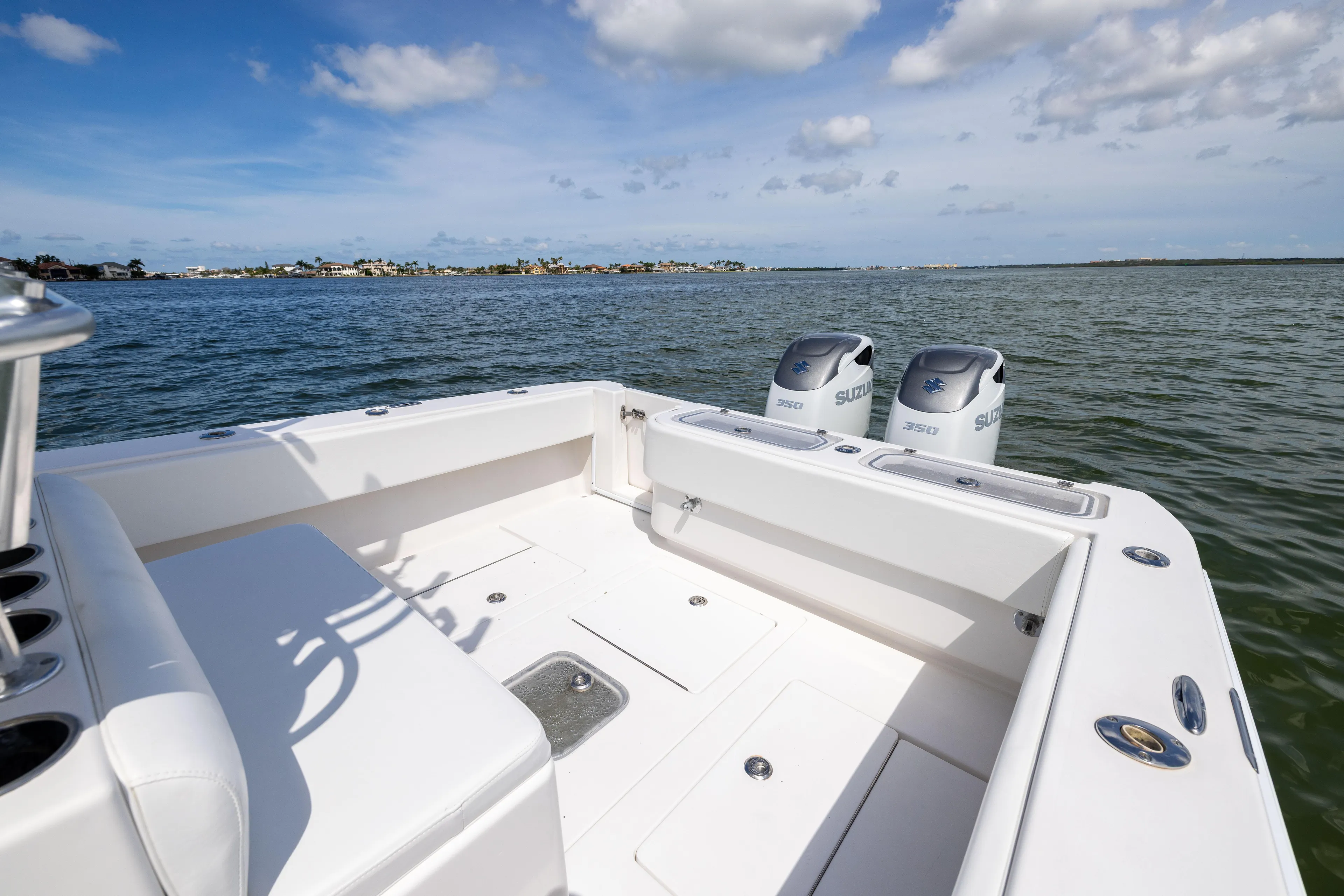  Yacht Photos Pics 2008 Contender 31 Open boat with twin Suzuki 350 engines on calm water.