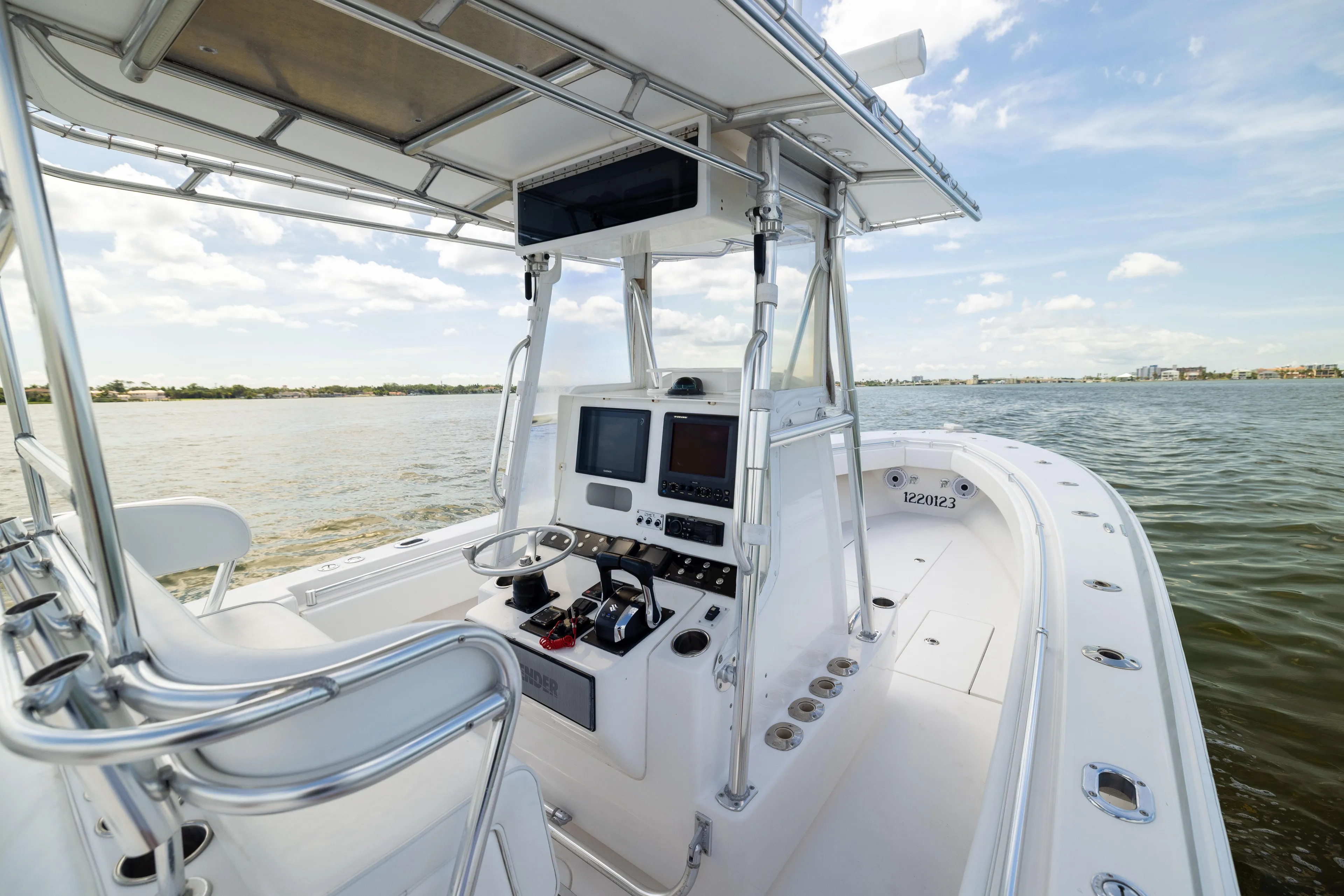  Yacht Photos Pics 2008 Contender 31 Open boat interior with navigation equipment on calm water.