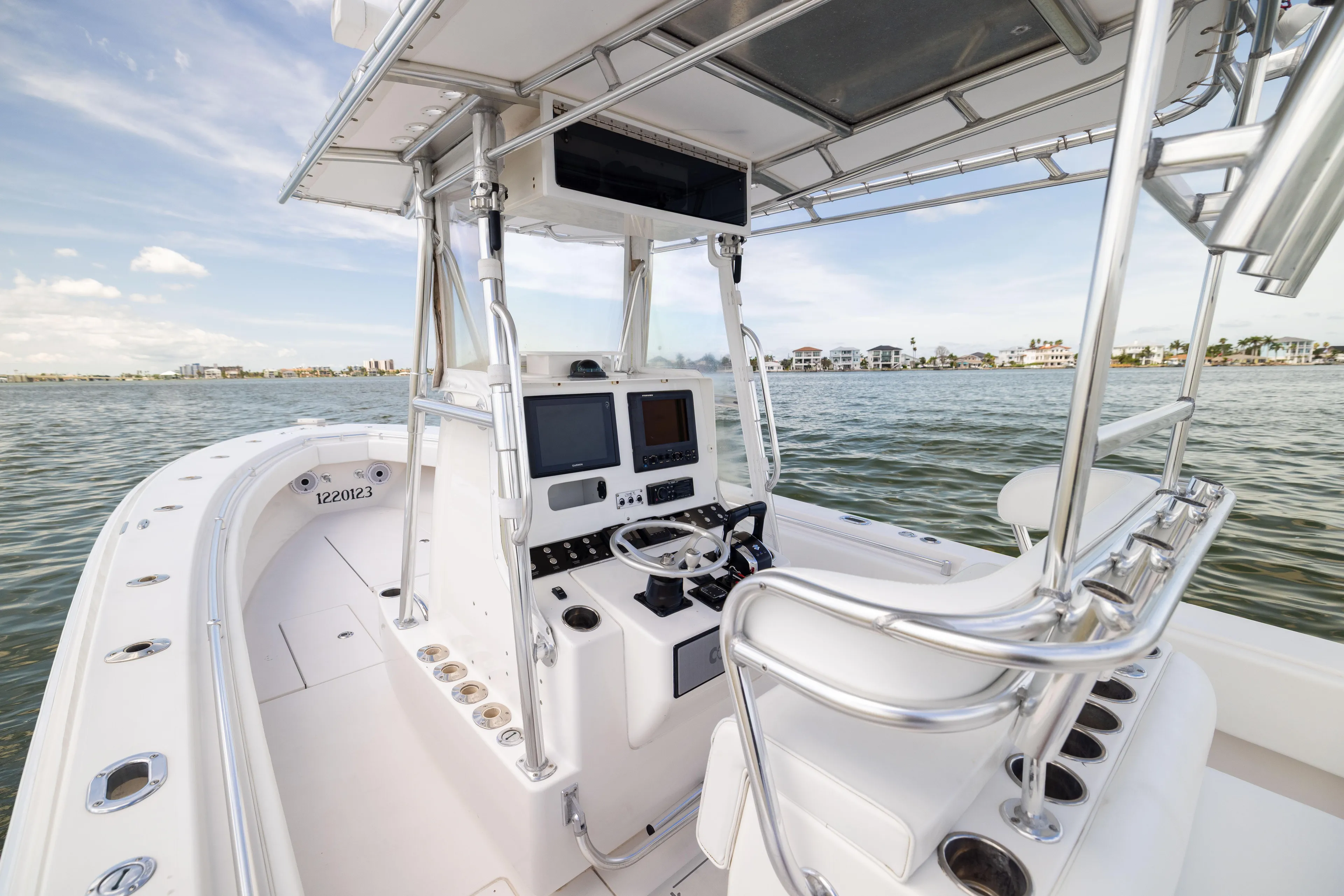  Yacht Photos Pics 2008 Contender 31 Open boat interior with navigation equipment on calm water.
