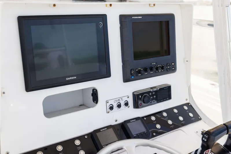  Yacht Photos Pics Control panel of a 2008 Contender 31 Open boat with Garmin and Furuno displays.