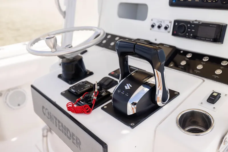  Yacht Photos Pics Control panel of a 2008 Contender 31 Open boat with steering wheel and throttle.