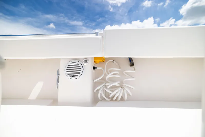  Yacht Photos Pics 2008 Contender 31 Open boat deck with coiled hose and speaker under blue sky.