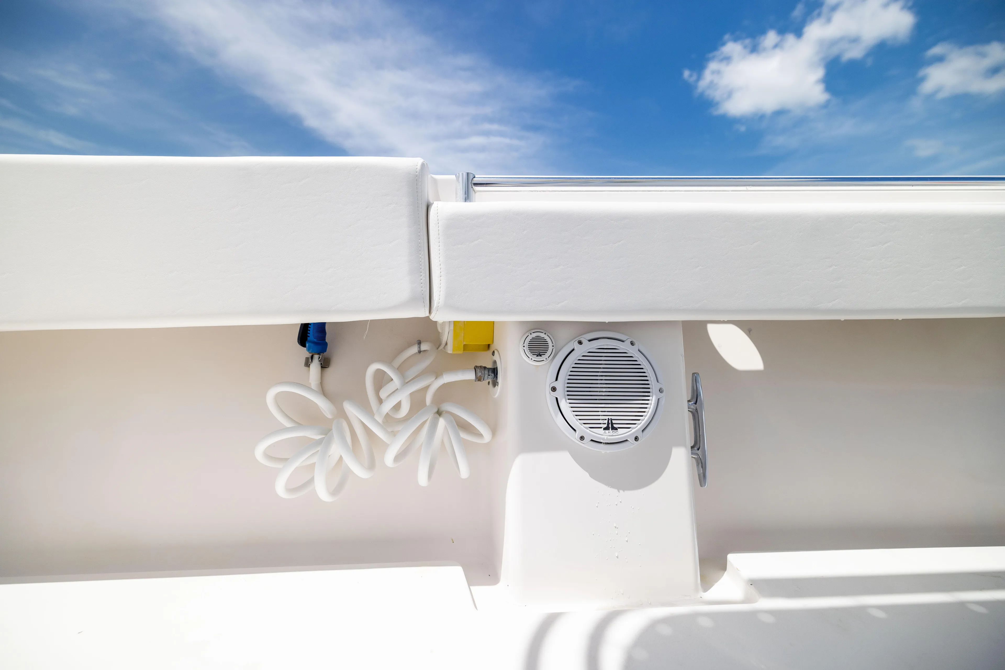  Yacht Photos Pics 2008 Contender 31 Open boat interior with speaker and coiled hose under blue sky.