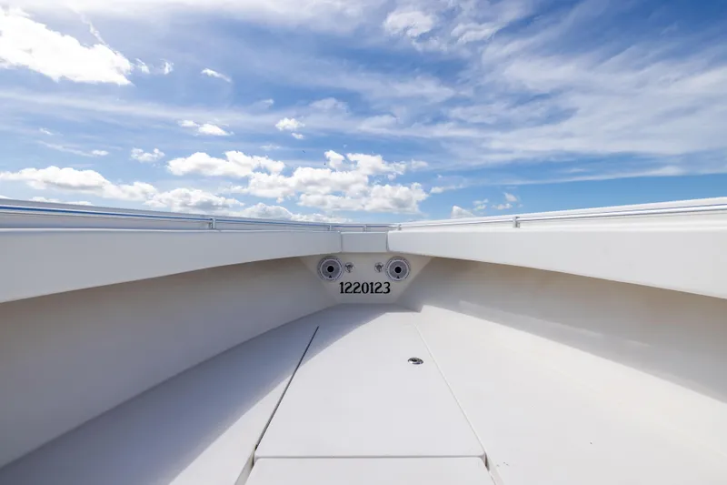  Yacht Photos Pics 2008 Contender 31 Open boat deck under a bright blue sky with clouds.