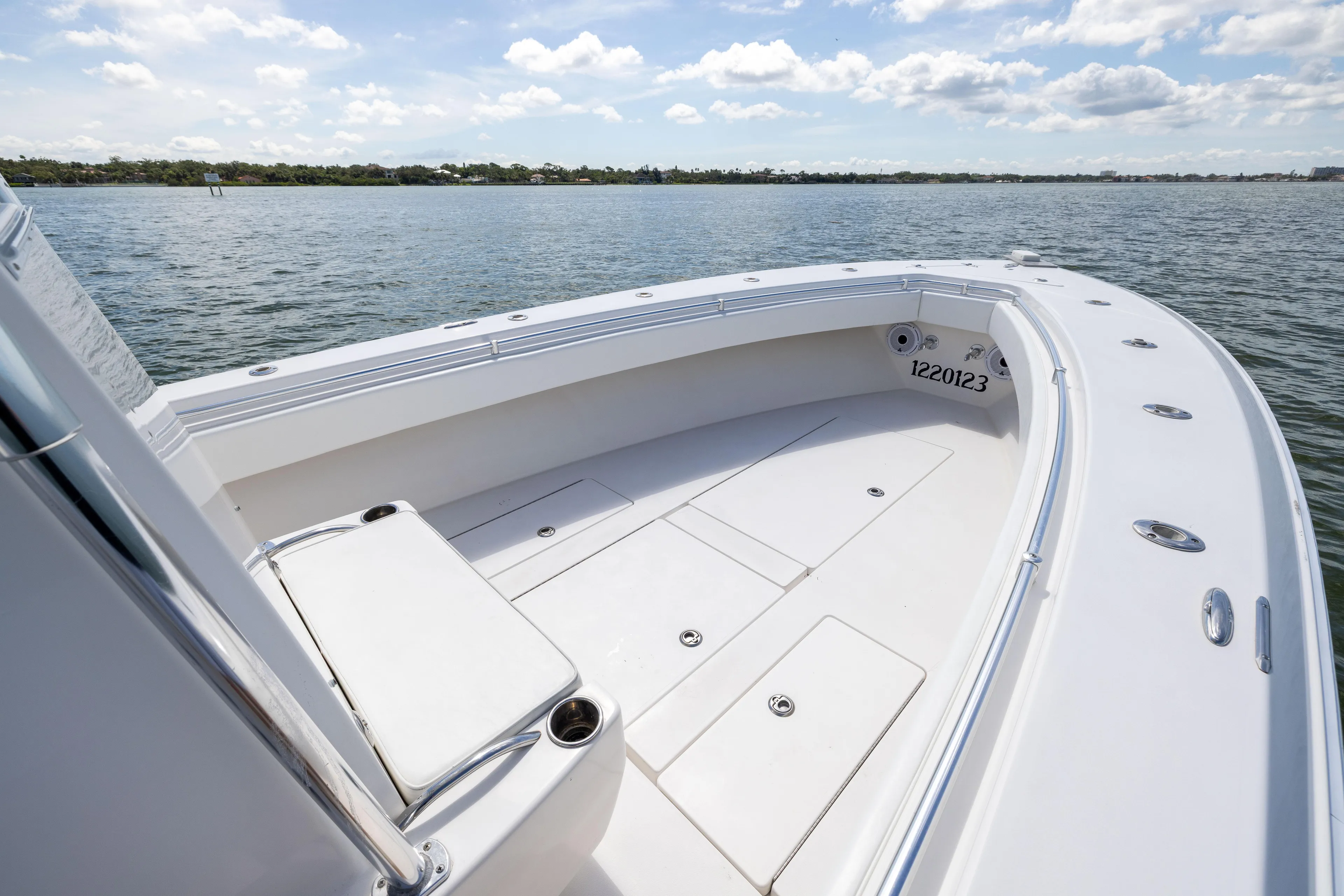  Yacht Photos Pics 2008 Contender 31 Open boat deck with seating, on calm water under a partly cloudy sky.