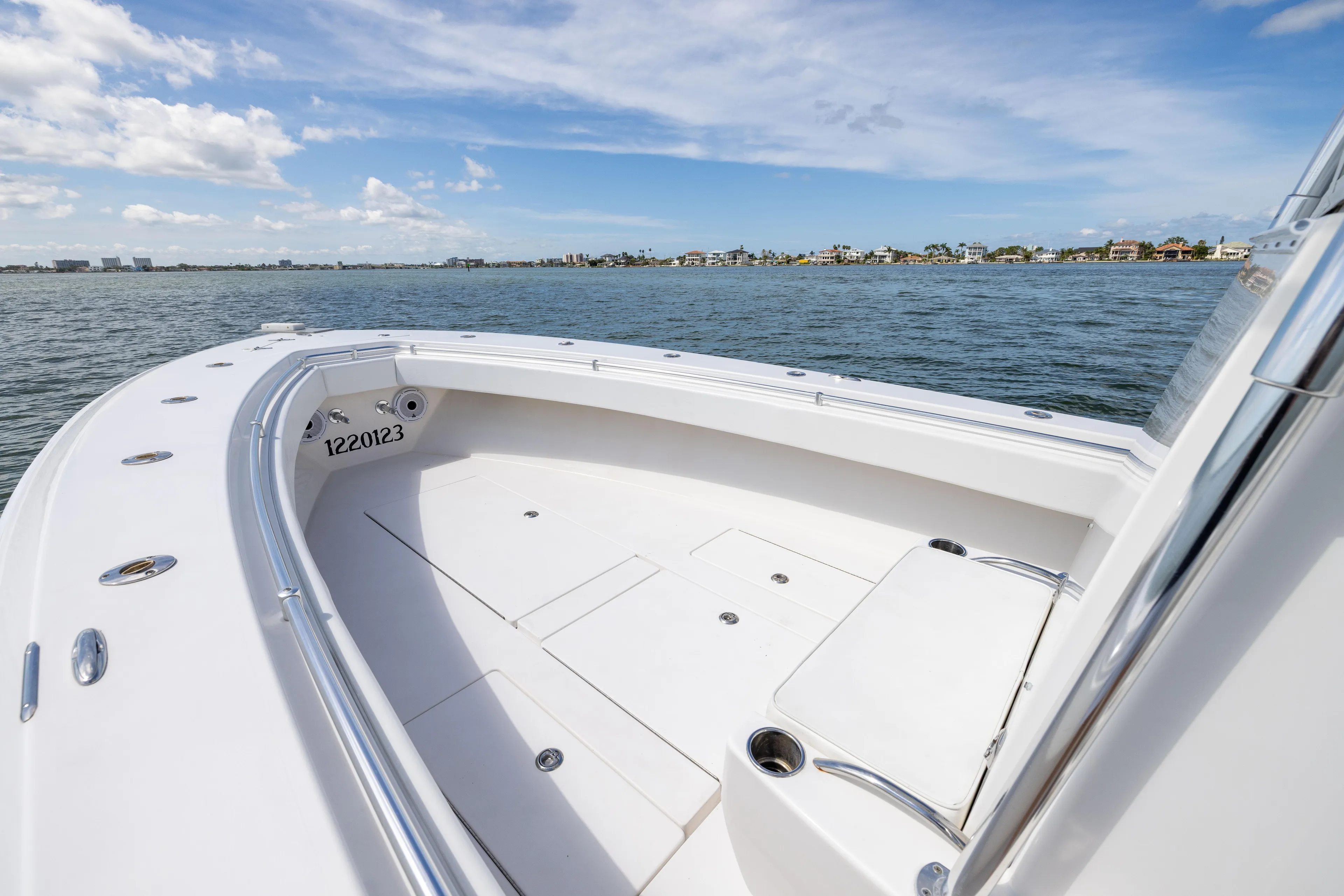  Yacht Photos Pics 2008 Contender 31 Open boat on water, clear sky, coastal view.